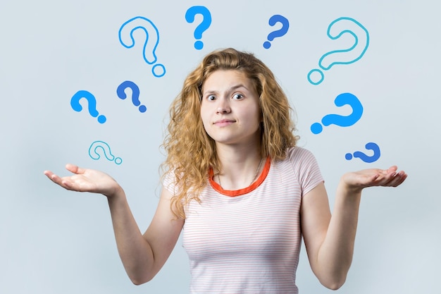 Image of a thinking young girl Looking camera have an idea Stands on a white background