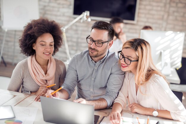 Image of three business people working at meeting