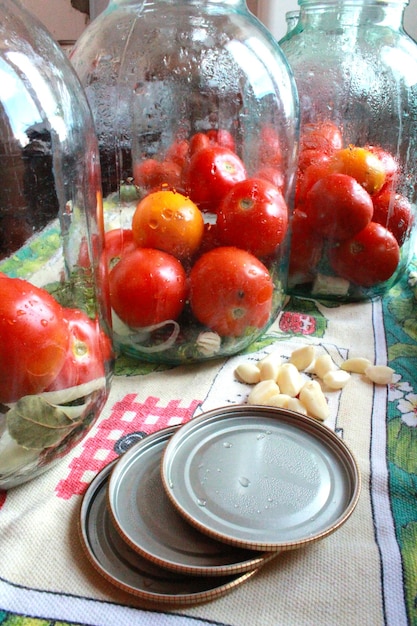 Image of tomatos in jars prepared for preservation