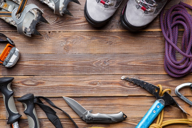 Image on top of ski poles, boots, picks on wooden background. Place for text.