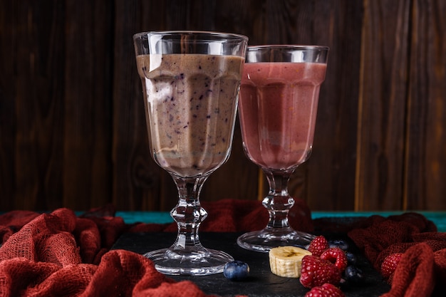 Image of two glasses with smoothies on table with cloth