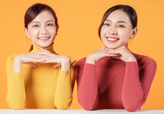 Image of two young Asian woman on background