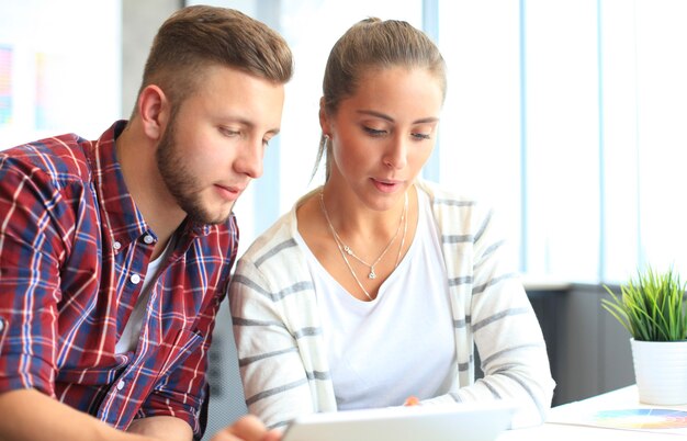 Image of two young business partners discussing plans or ideas at meeting