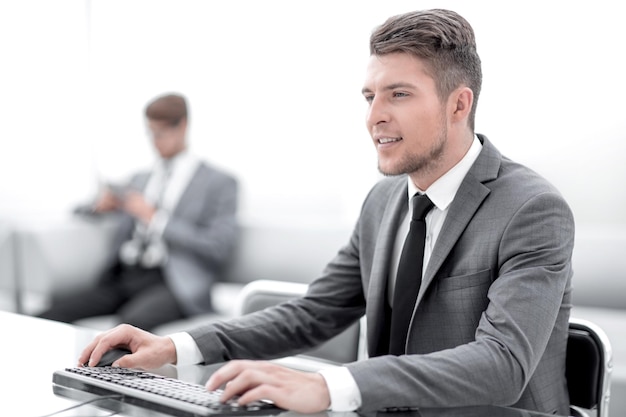 Image of two young colleagues work in office using computers and telephone