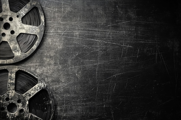 Photo image of vintage film reels on a textured dark background evoking nostalgia for classic cinema and filmmaking