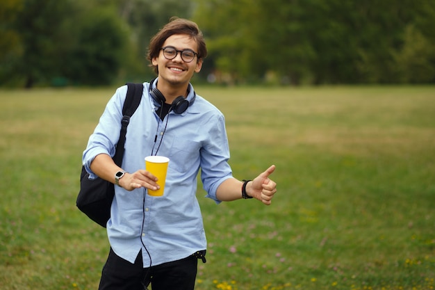 Image with a happy student drinking his coffee