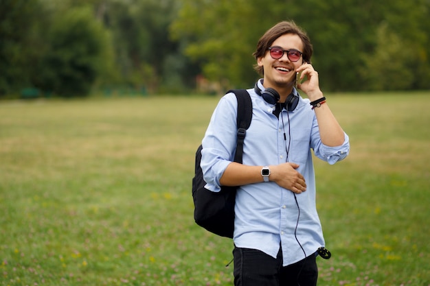 Image with a happy student walking on campus