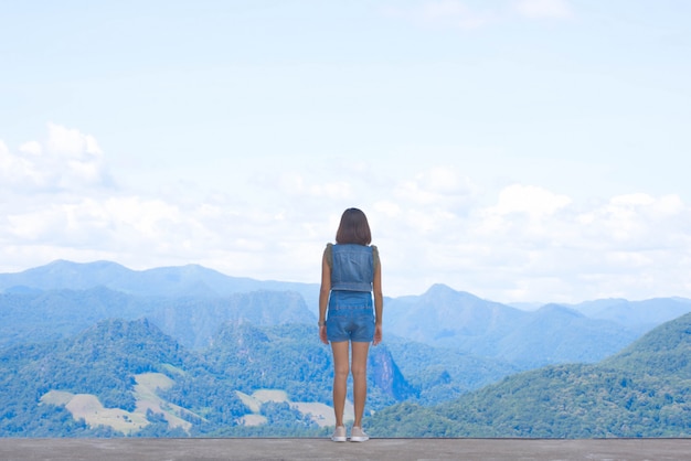 The image behind the women  looked at the mountains and trees.