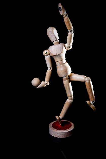 Image of wooden manikin on black background poses different posing