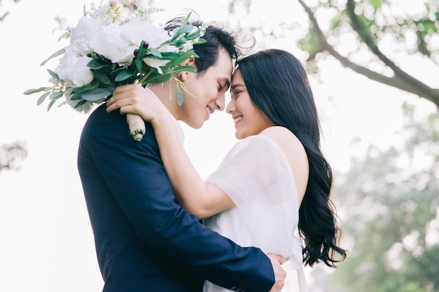 Image of young Asian bride and groom