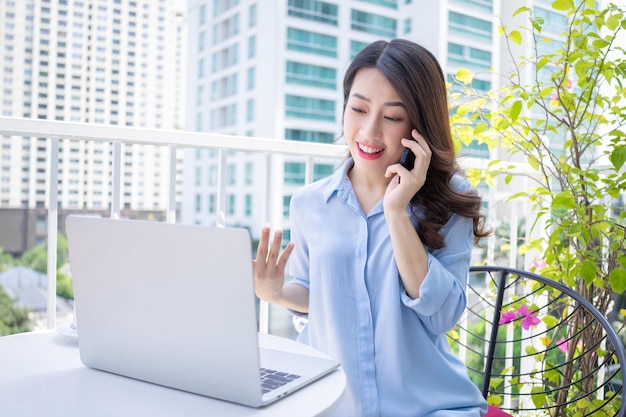 Image of young Asian business woman working at home