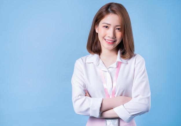 Image of young Asian businesswoman on blue background