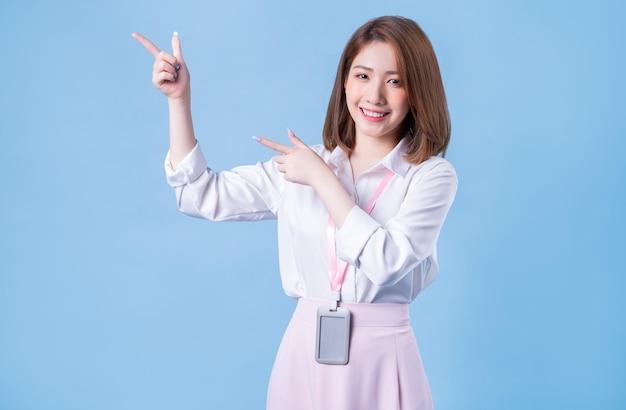 Image of young Asian businesswoman on blue background