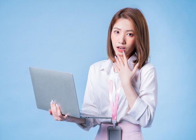 Image of young Asian businesswoman on blue background