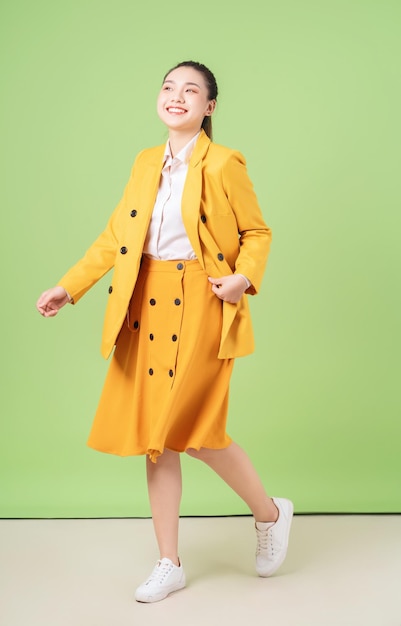 Image of young Asian businesswoman on green background