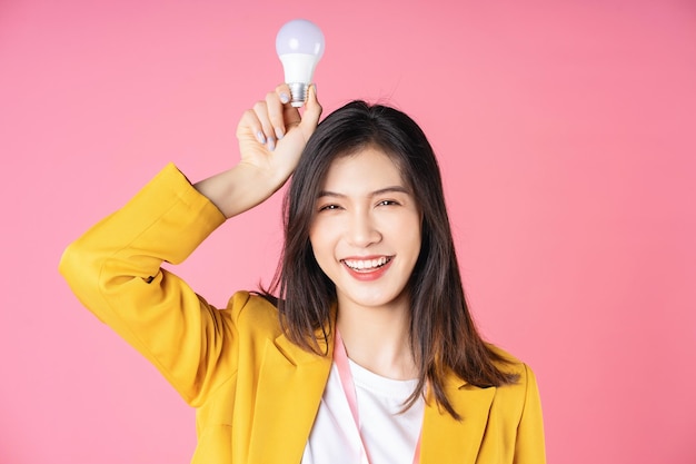 Image of young Asian businesswoman holding light bulb brainstorm concept