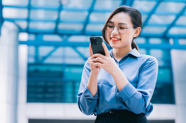 Image of young Asian businesswoman outside