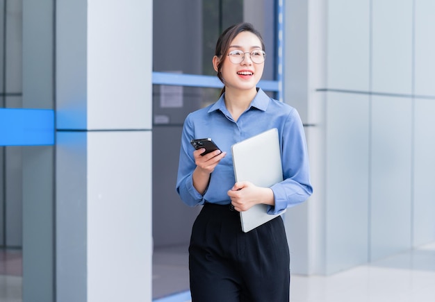 Image of young Asian businesswoman outside