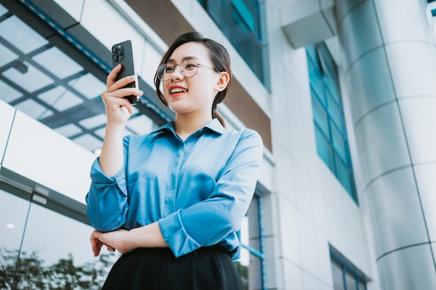 Image of young Asian businesswoman outside