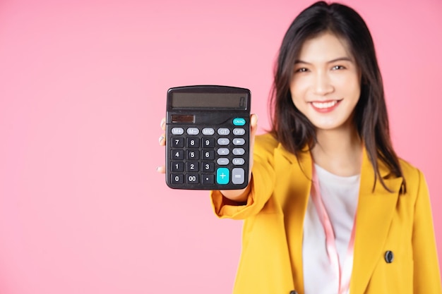 Image of young Asian businesswoman using calculator