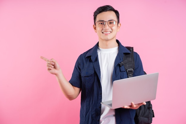 Image of young Asian college student on pink background