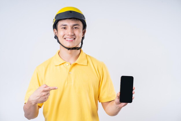 Image of young Asian delivery man on background