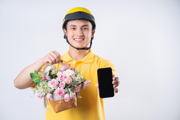 Image of young Asian delivery man on background