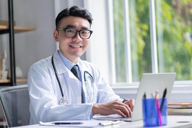 Image of young Asian doctor working at clinic