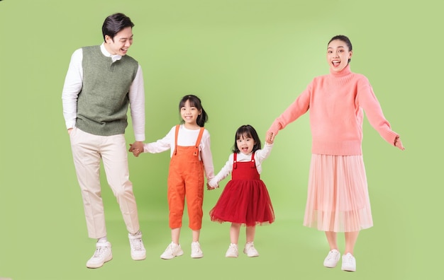 Image of young Asian family on background