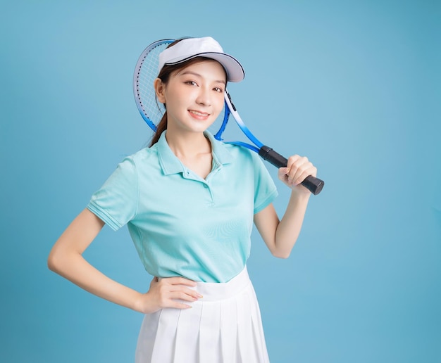 Image of young Asian girl playing tennis