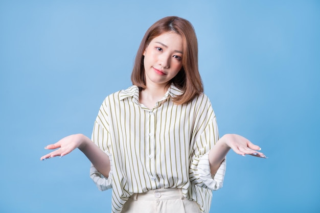 Image of young Asian girl posing on blue background