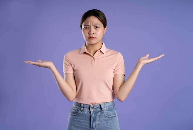 Image of young asian girl posing on purple background