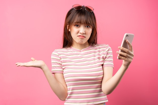 Image of young Asian girl wearing pink t-shirt on pink