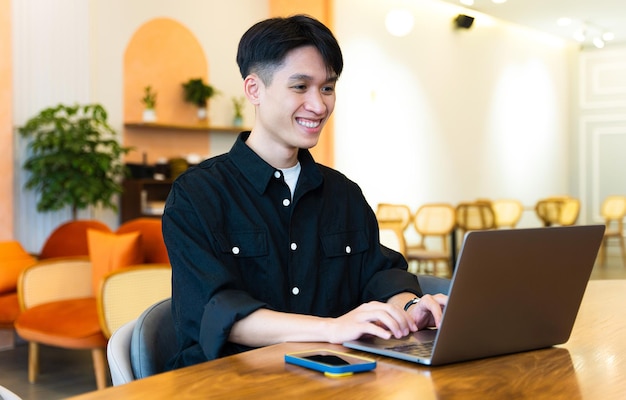 Image of young Asian male working at a cafe