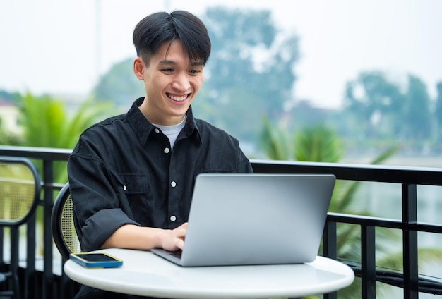 Image of young Asian male working at a cafe