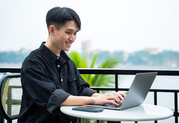 Image of young Asian male working at a cafe