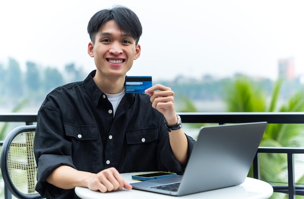 Image of young Asian male working at a cafe