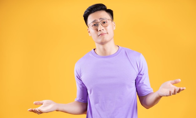 Image of young Asian man posing on background