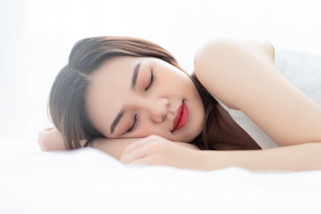 Image of young Asian woman in bed