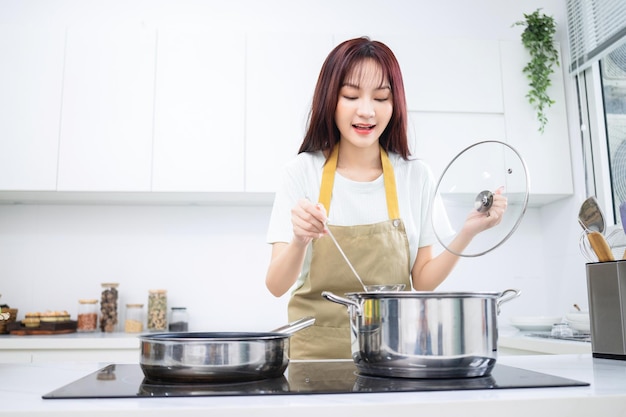 Image of young Asian woman in the kitchen