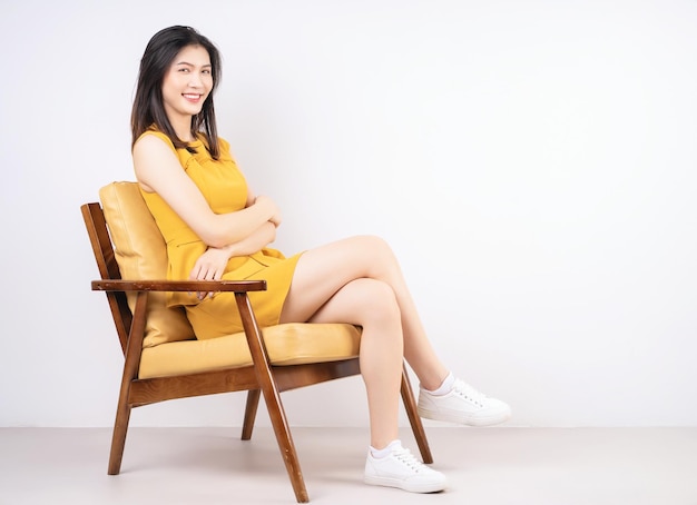 Image of young Asian woman sitting on chair