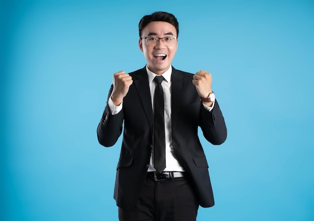 Image of young businessman posing on blue background