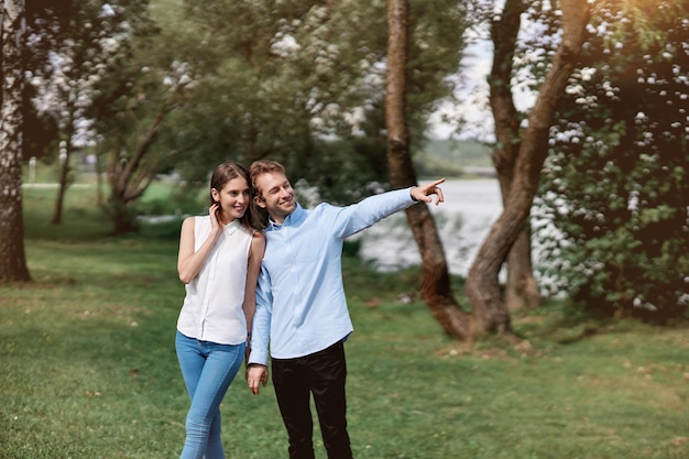 Image of a young couple on a walk along the lake shore