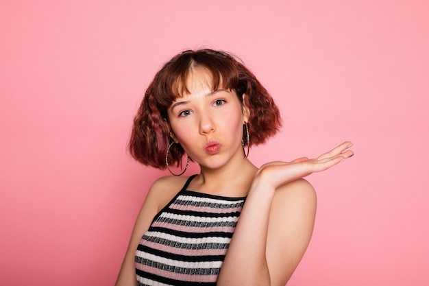 Image of young happy beautiful woman posing isolated over pink wall background.
