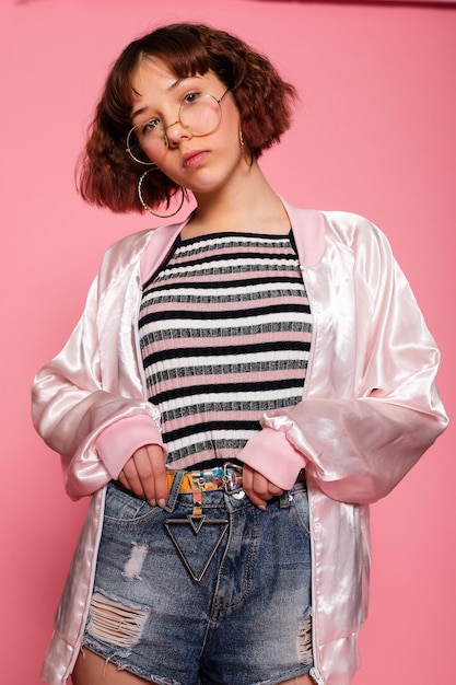 Image of young happy beautiful woman posing isolated over pink wall background