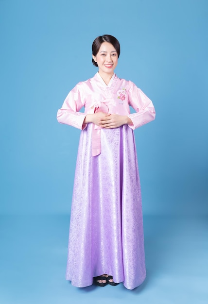 Image of young Korean woman wearing hanbok on background