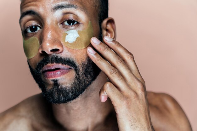 Image of a young man taking care of his skin