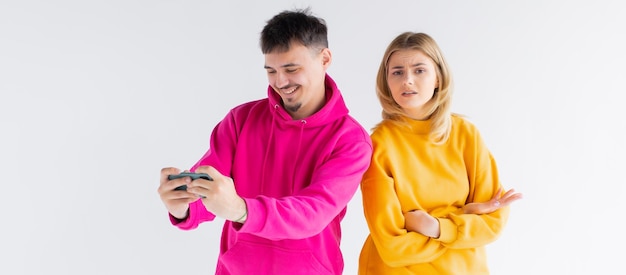 Image of young woman spying and peeking at cellphone of her boyfriend