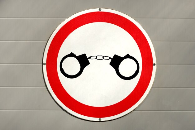 Images of handcuffs on a road sign. road crime concept. High quality photo