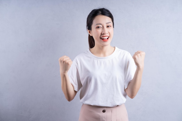 Imagr of young Asian woman posing on background